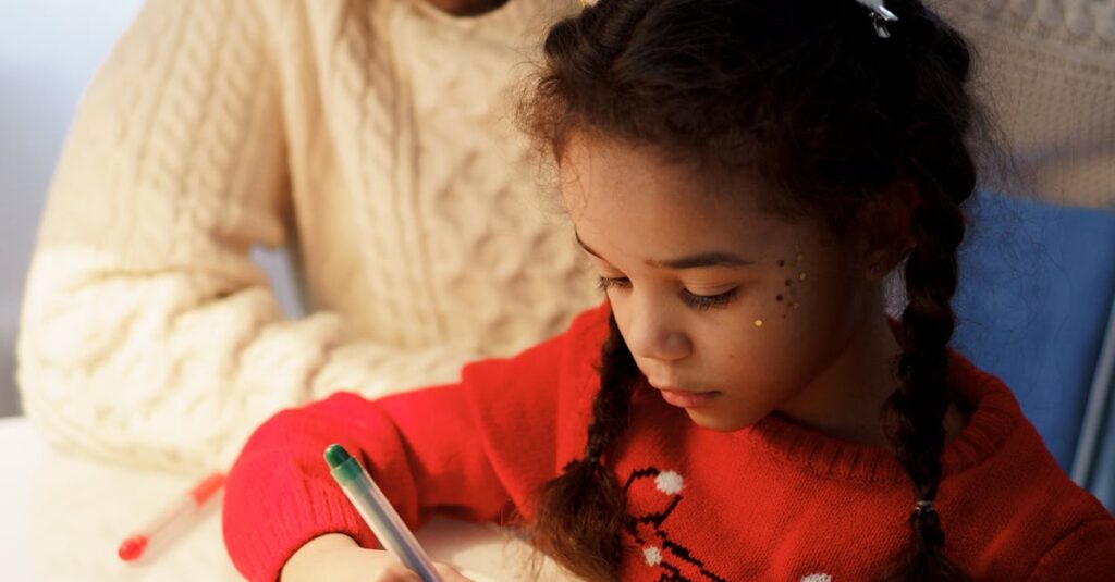 A father and daughter making Christmas crafts together at home, highlighting family bonding and creativity during the holiday season.