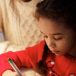 A father and daughter making Christmas crafts together at home, highlighting family bonding and creativity during the holiday season.