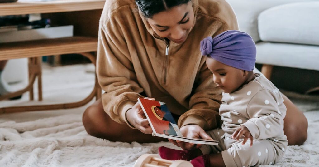 A mother and her baby bonding over a book on the floor of a cozy living room.