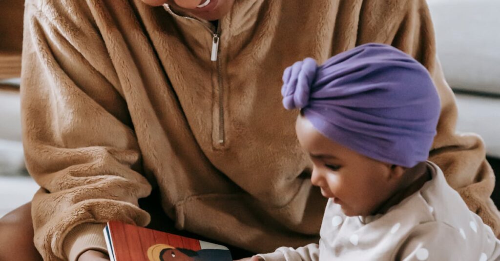 A mother and her baby enjoying a bonding moment while reading indoors.