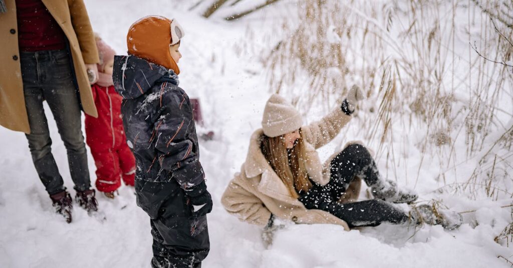 A joyful family enjoying a snowy winter day outdoors, playing and laughing together.