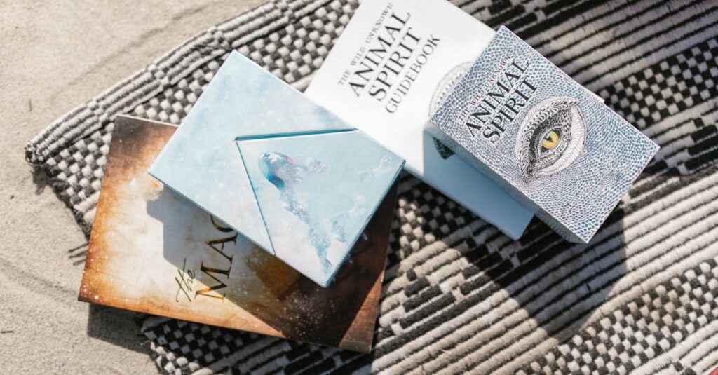 Animal spirit guidebooks placed on a patterned beach blanket in sunlight.