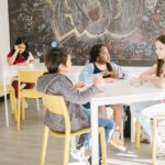 Children in a classroom with diverse cultural backgrounds sharing a learning moment.