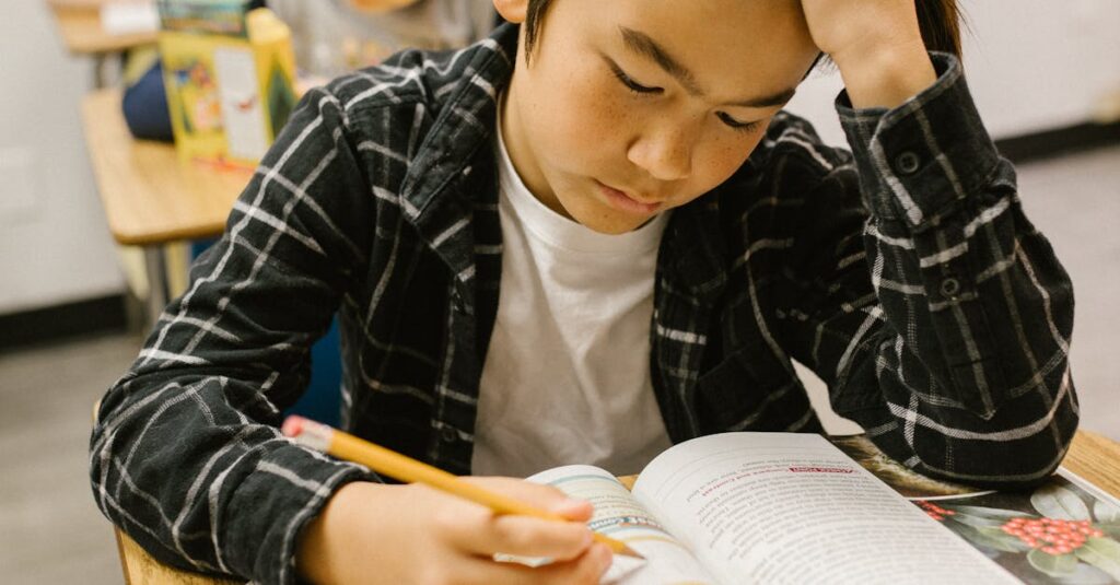 Students studying attentively at their desks in a classroom environment.