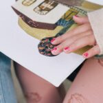Close-up of a child exploring a braille storybook with colorful illustrations, emphasizing tactile learning.