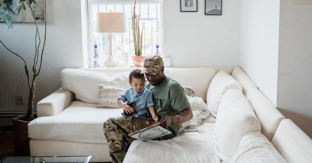 A father and son enjoy bonding time together, reading in a cozy living room.