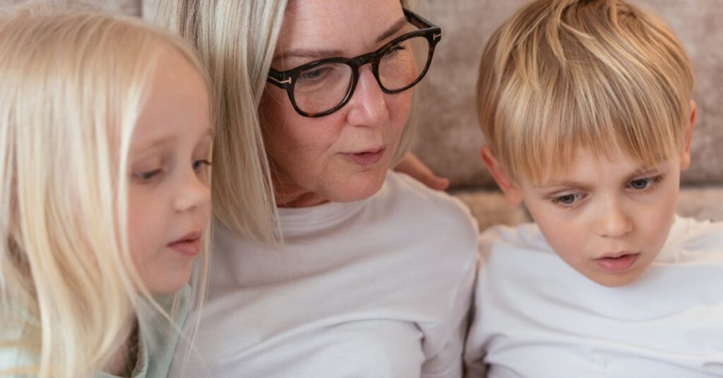 A grandmother and her grandchildren enjoy quality time together indoors.