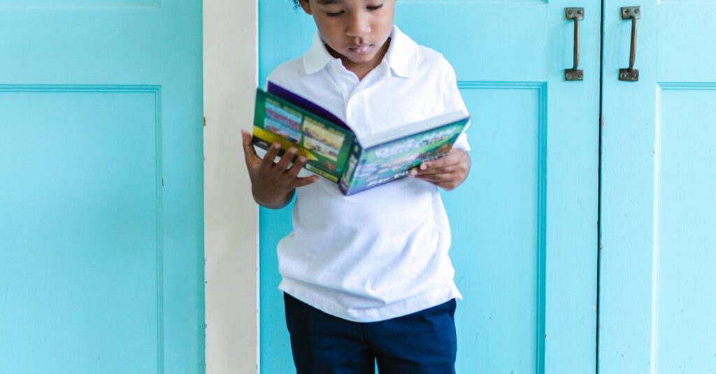 Charming scene of a young boy immersed in reading a book, standing by turquoise doors indoors.