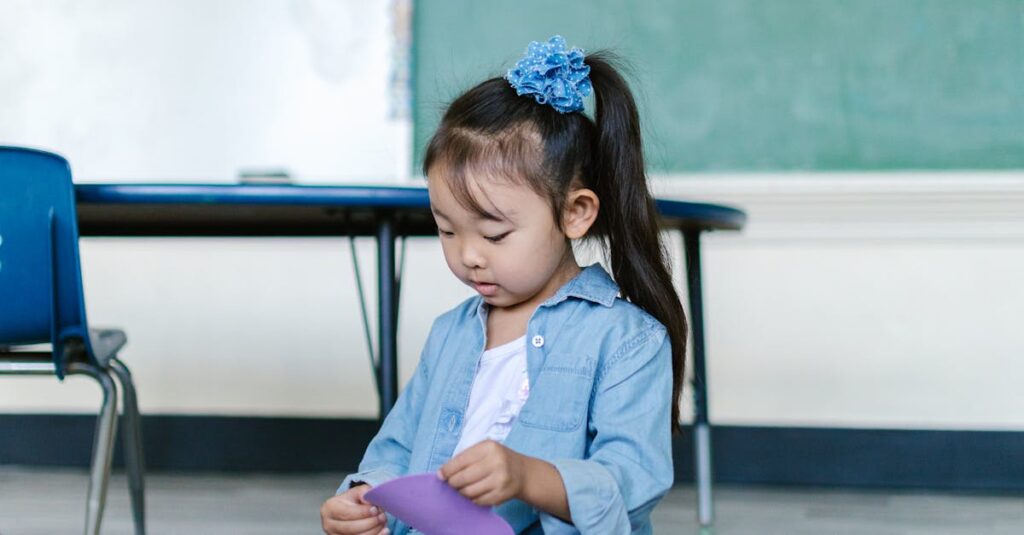 Young girl in a classroom setting, engaging with colorful paper toys, emphasizing early childhood education and creativity.