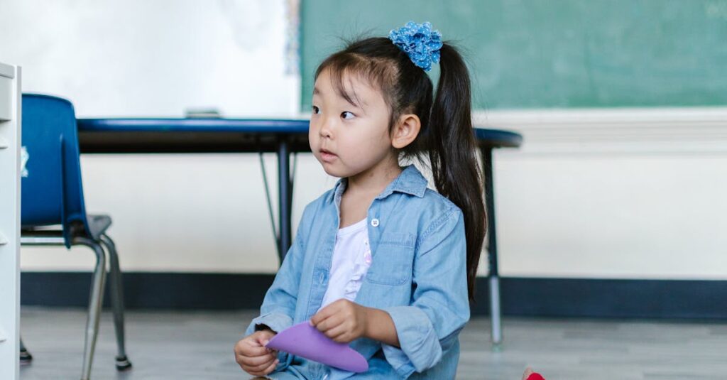 Cute young girl in a preschool classroom playing with colorful toys on a carpet.
