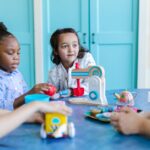 Young children engaged in play with toys and a teacher in a colorful preschool setting.
