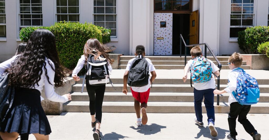 Group of students with backpacks running into school, captured from behind, showing excitement.