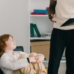 A child and therapist in a modern office during a psychotherapy session, emphasizing education and development.