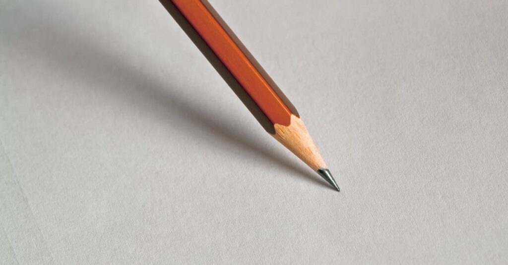 Detailed close-up of a wooden pencil resting on white paper, perfect for educational themes.