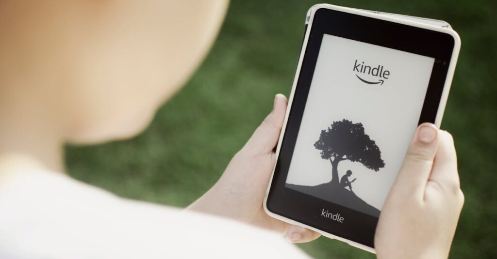 A child holds a Kindle device outdoors, highlighting the ease of reading with technology.