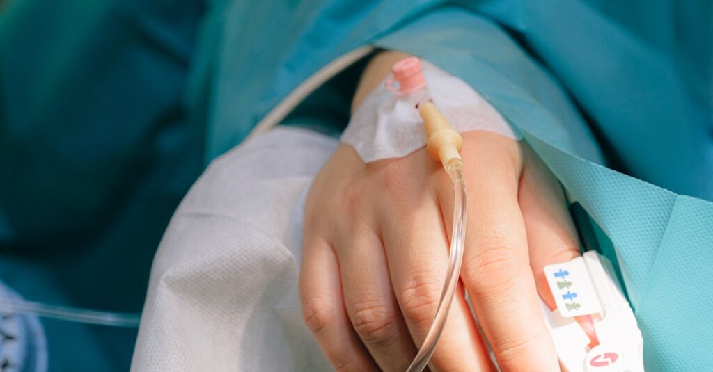 Close-up of a patient's hand with intravenous therapy and pulse oximeter, symbolizing healthcare and treatment.