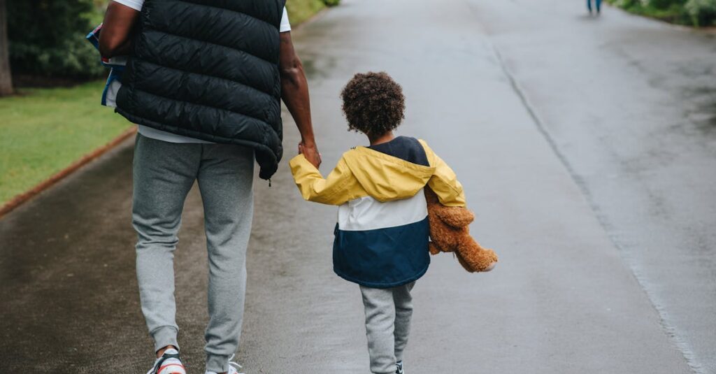 A father and son enjoying a walk in the city, holding hands on a rainy day.