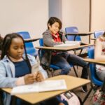 Students engaged in a classroom setting, focusing on reading and learning activities.