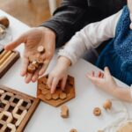 Child engaged in play with wooden educational toys on a table, fostering creativity and learning.