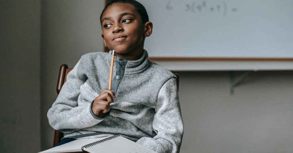 Concentrated African American boy in casual outfit sitting on chair with pencil and copybook and thinking how to do task