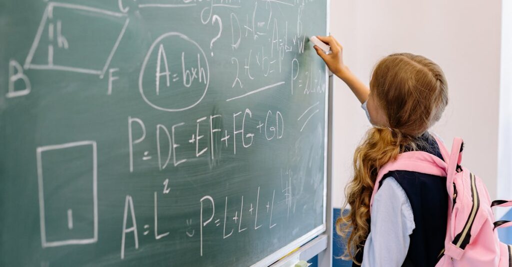 Young girl student writing math equations on classroom blackboard during a lesson.